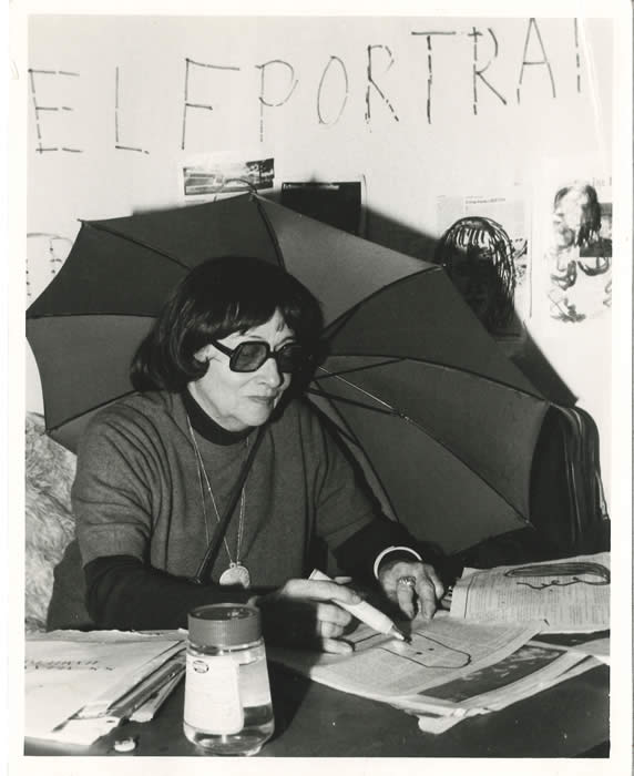 Lil Picard drawing self portrait sketches on newspapers, likely 1968